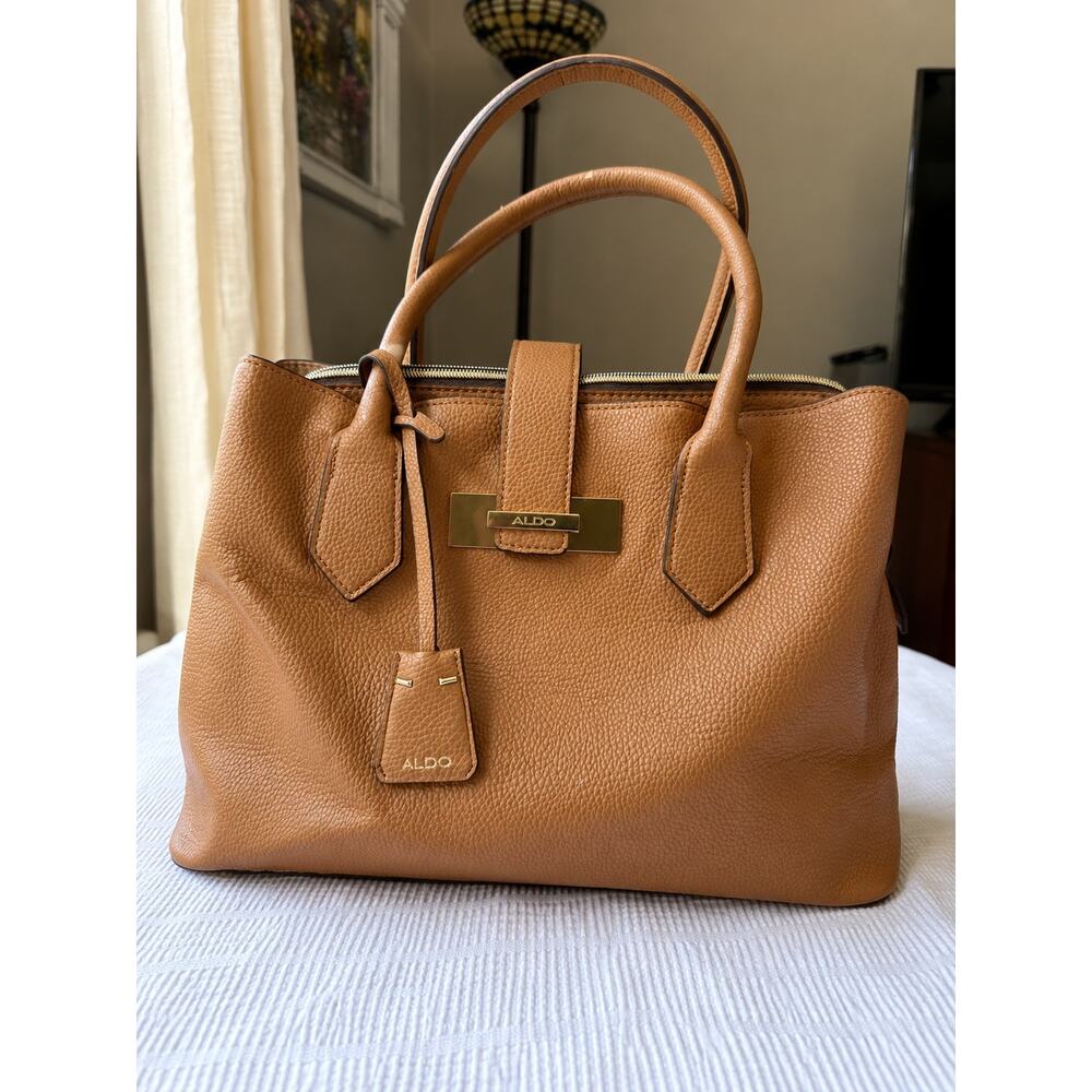 Aldo handbag features a structured top-handle design with a prominent gold